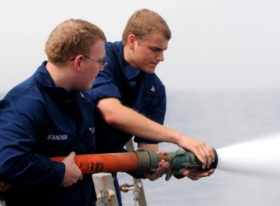 US Navy 110713-N-TB177-164 Sailors onduct hose handling trining during a general quarters drill aboard the guided-missile destroyer USS Truxtun (DD