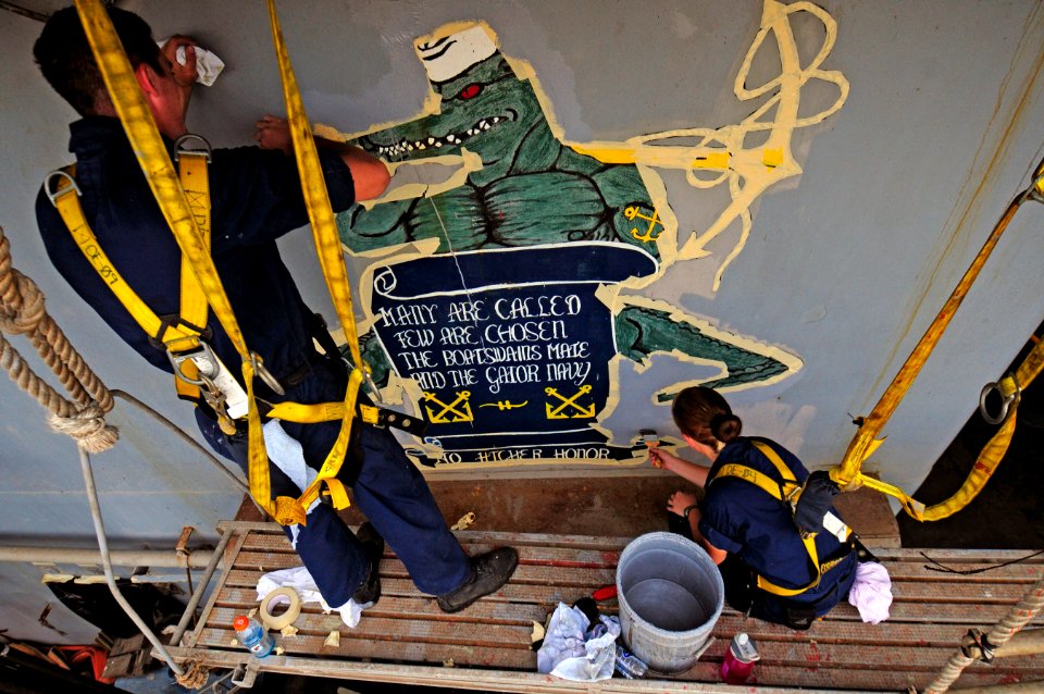 US Navy 110713-N-RC734-112 Seaman Recruit Samuel Harper, left, and Seaman Apprentice Naomi Bentley touch up a mural aboard the amphibious dock land