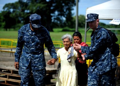 US Navy 110715-N-NY820-044 Hospitalman Jabarae Person, left, and Lt. Jason Switzer escort a patient into the clinic during a Continuing Promise 201 photo