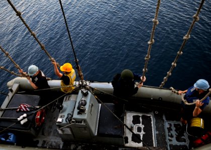 US Navy 110714-N-KB052-033 Sailors aboard the Ticonderoga-class guided-missile cruiser USS Cowpens (CG 63) lower a rigid-hull inflatable boat for a