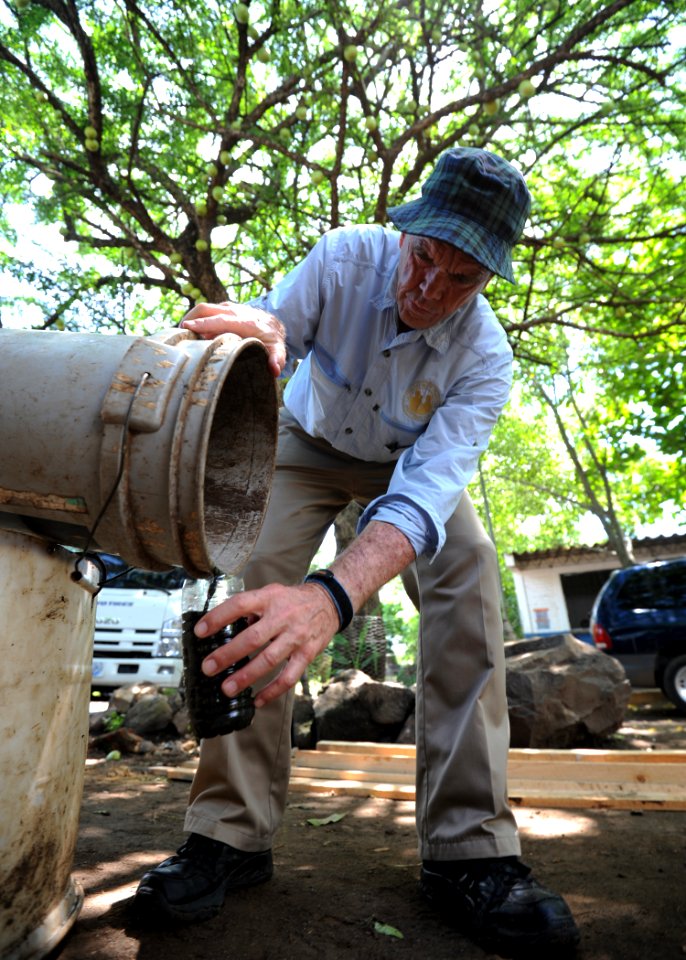 US Navy 110716-N-NY820-151 Latter-day Saints Charities volunteer Ken Kartchner, from Provo, Utah, takes a water sample from a septic tank for the C