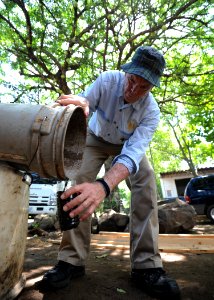 US Navy 110716-N-NY820-151 Latter-day Saints Charities volunteer Ken Kartchner, from Provo, Utah, takes a water sample from a septic tank for the C