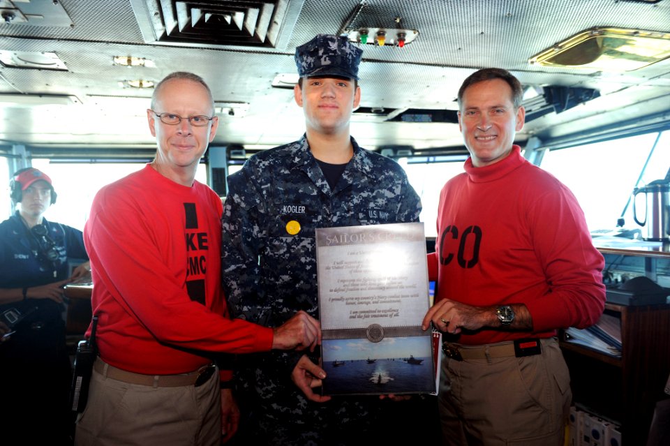 US Navy 110718-N-AU622-083 Mass Communication Specialist 3rd Class Erick Kogler, center, displays a