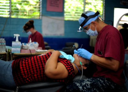 US Navy 110717-N-NY820-078 Hospital Corpsman 1st Class Darwin Flores, from San Salvador, El Salvador, performs a dental cleaning during a Continuin