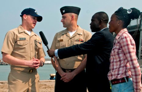 US Navy 110717-N-XK513-055 Lt. j.g. Adam Cole, left, future operations officer for High Speed Vessel Swift (HSV 2), responds to questions from loca