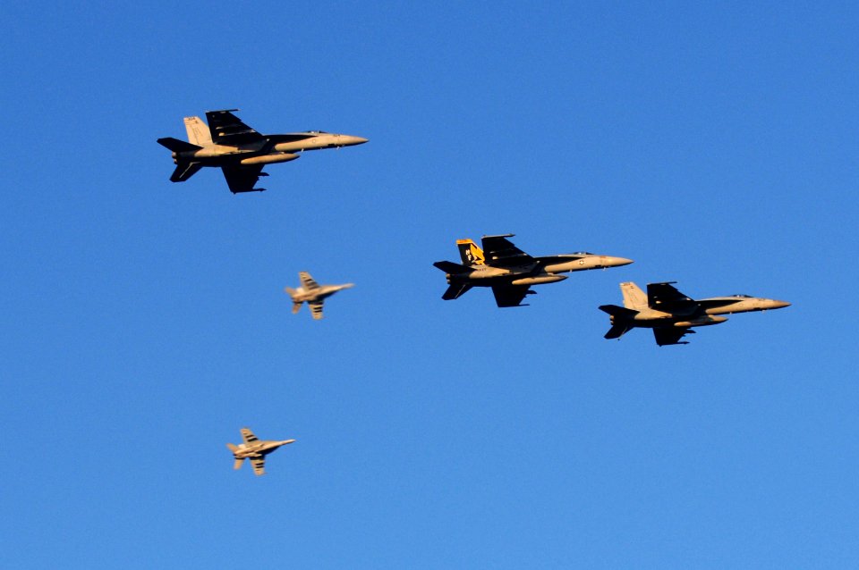 US Navy 110718-N-IO627-130 F-A-18 Hornets fly over the guided-missile destroyer USS Curtis Wilbur (DDG 54) after participating in a simulated air s