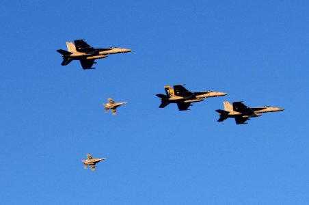 US Navy 110718-N-IO627-130 F-A-18 Hornets fly over the guided-missile destroyer USS Curtis Wilbur (DDG 54) after participating in a simulated air s