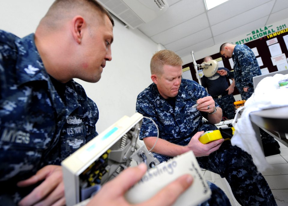 US Navy 110716-F-ET173-107 Biomedical repair technicians embarked aboard the Military Sealift Command hospital ship USNS Comfort (T-AH 20) repair e