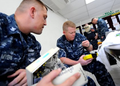 US Navy 110716-F-ET173-107 Biomedical repair technicians embarked aboard the Military Sealift Command hospital ship USNS Comfort (T-AH 20) repair e photo