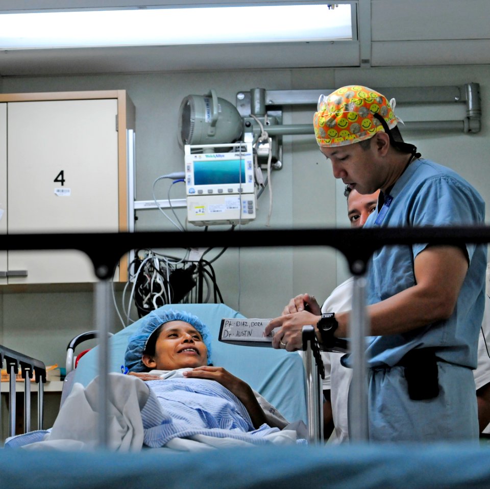 US Navy 110720-N-EP471-093 Members of the Continuing Promise 2011 surgical team talk with a Salvadoran patient before surgery aboard the Military S