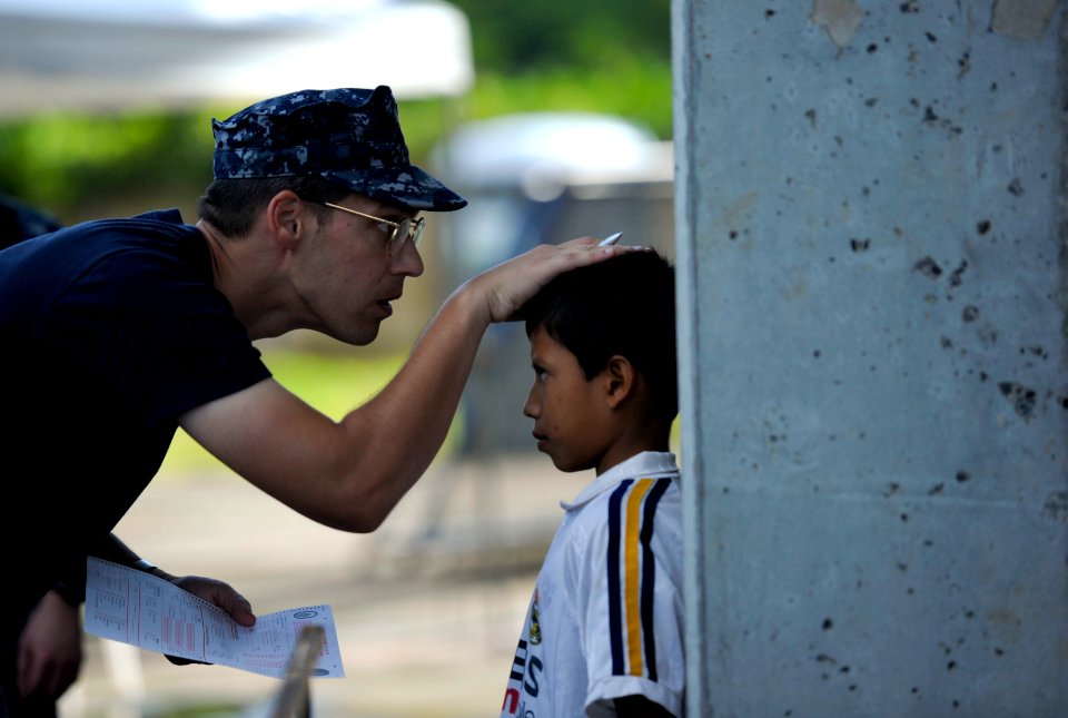 US Navy 110718-N-RM525-058 Cmdr. Jason Layton, from Wexford, Penn., measures a Salvadoran boy during a Continuing Promise 2011 community service me