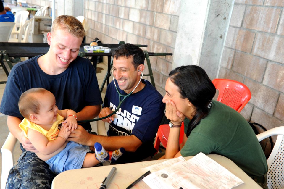 US Navy 110719-F-ET173-304 Midshipman Andrew Marthy, left, from Albany, N.Y., Project Hope volunteer Jeff Cukor, from Worcester, Mass., and Brazili