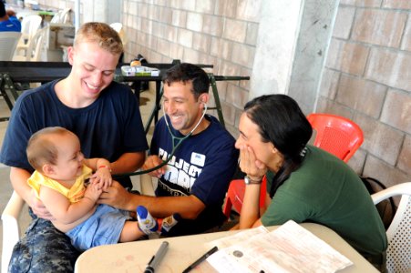US Navy 110719-F-ET173-304 Midshipman Andrew Marthy, left, from Albany, N.Y., Project Hope volunteer Jeff Cukor, from Worcester, Mass., and Brazili