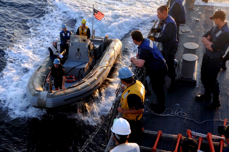 US Navy 110718-N-IO627-006 A rigid-hull inflatable boat pulls alongside the guided-missile destroyer USS Curtis Wilbur (DDG 54) after conducting st