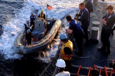 US Navy 110718-N-IO627-006 A rigid-hull inflatable boat pulls alongside the guided-missile destroyer USS Curtis Wilbur (DDG 54) after conducting st