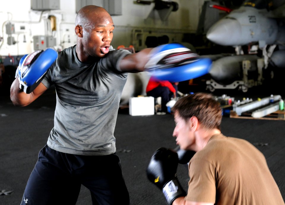 US Navy 110719-N-QL471-673 Aircrew Survival Equipmentman Airman Rashard Lovelace practices boxing in the hangar bay aboard the aircraft carrier USS