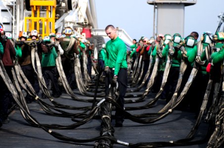 US Navy 110718-N-SB672-088 Sailors stow an aircraft barricade after flight deck drills aboard the aircraft carrier USS Ronald Reagan (CVN 76) photo