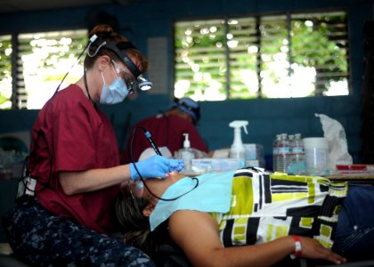US Navy 110717-N-NY820-061 Hospital Corpsman 1st Class Kimberly Edwards, from Louisville, Ky., performs a dental cleaning during a Continuing Promi photo