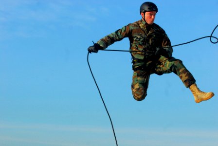 US Navy 110720-N-WW409-254 Navy Diver 2nd Class Jonathan Peglow, assigned to Explosive Ordnance Disposal Mobile Unit (EODMU) 5, rappels off a tower