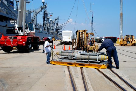 US Navy 110720-N-FO412-001 Personnel assigned to Naval Munitions Command offload ordnance from the Military Sealift Command fast combat support shi
