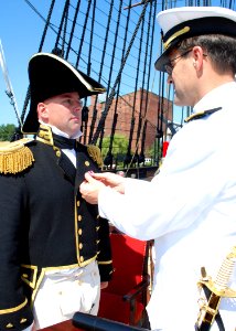 US Navy 110722-N-AU127-210 Vice Adm. John Bird, Director Navy Staff, right, presents Cmdr. Tim Cooper, 71st commanding officer of USS Constitution