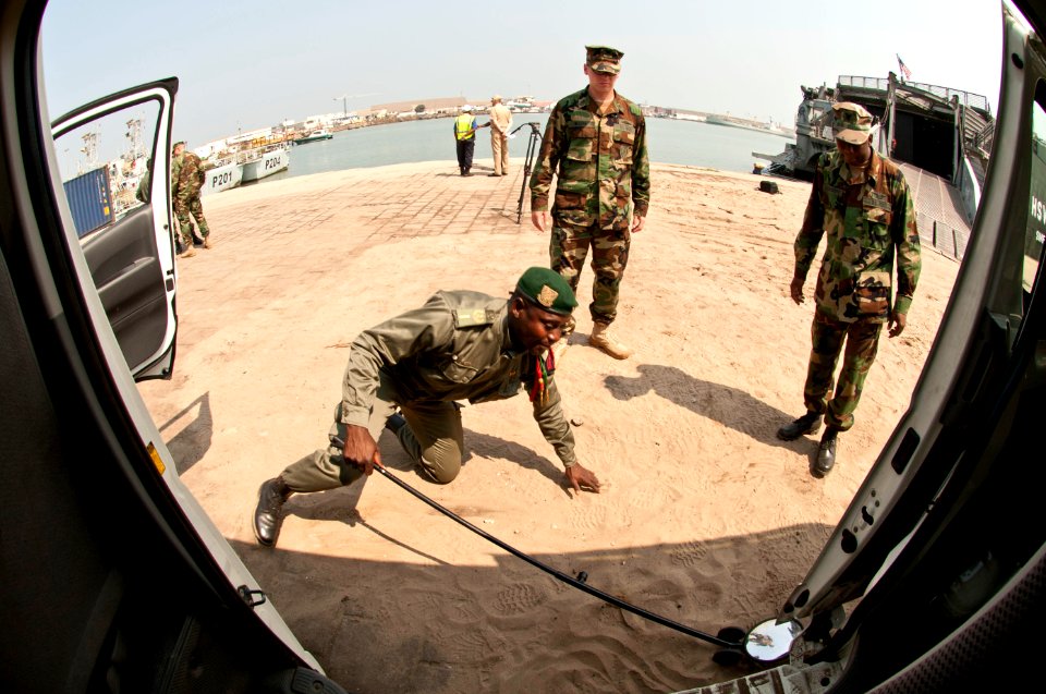 US Navy 110721-N-XK513-078 A member of the Congolese military practices inspecting a vehicle under the supervision of U.S. Navy instructors as part
