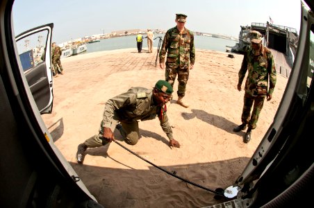 US Navy 110721-N-XK513-078 A member of the Congolese military practices inspecting a vehicle under the supervision of U.S. Navy instructors as part