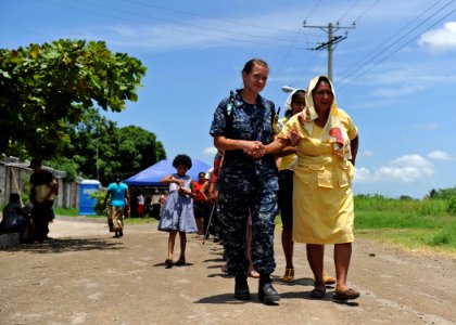 US Navy 110719-F-ET173-279 Hospital Corpsman 2nd Class Amanda Johnson, from Bedford, Penn., helps a Salvadoran woman photo