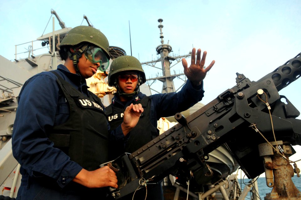 US Navy 110722-N-IO627-187 Gunner's Mate 2nd Class Christopher Sollano, right, shows Sonar Technician (Surface) 3rd Class J'nay Bann how to prime a