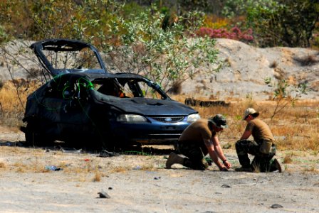 US Navy 110720-N-WW409-626 Navy Diver 2nd Class Jonathan Peglow and Explosive Ordnance Disposal 1st Class Karen McMillan, assigned to Explosive Ord photo