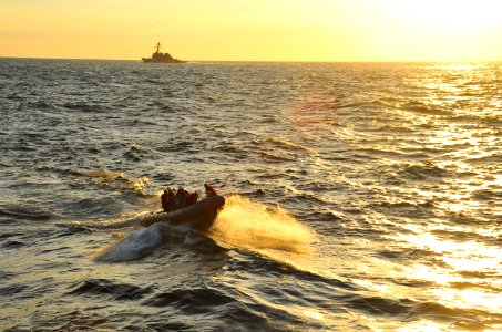 US Navy 110720-N-MH885-035 Sailors assigned to the aircraft carrier USS George Washington return to the ship in a rigid-hull inflatable boat after