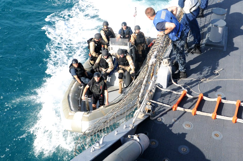 US Navy 110721-N-IO627-089 The visit, board, search, and seizure team pulls alongside the guided-missile destroyer USS Curtis Wilbur (DDG 54) in a