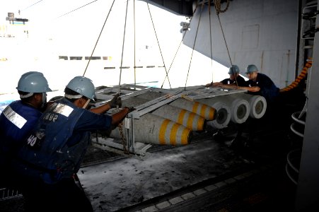 US Navy 110721-N-AU622-046 Sailors transport ordnance during an ammunition onload aboard USS Dwight D. Eisenhower (CVN 69)