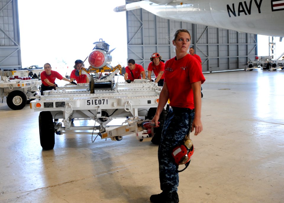 US Navy 110720-N-PP197-006 Aviation Ordnanceman Airman Michelle Boatman hauls an AGM-65 Maverick air-to-ground tactical missile to load on a P-3C O