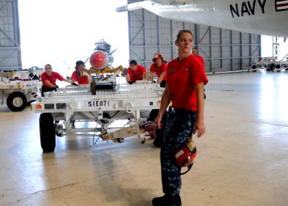 US Navy 110720-N-PP197-006 Aviation Ordnanceman Airman Michelle Boatman hauls an AGM-65 Maverick air-to-ground tactical missile to load on a P-3C O