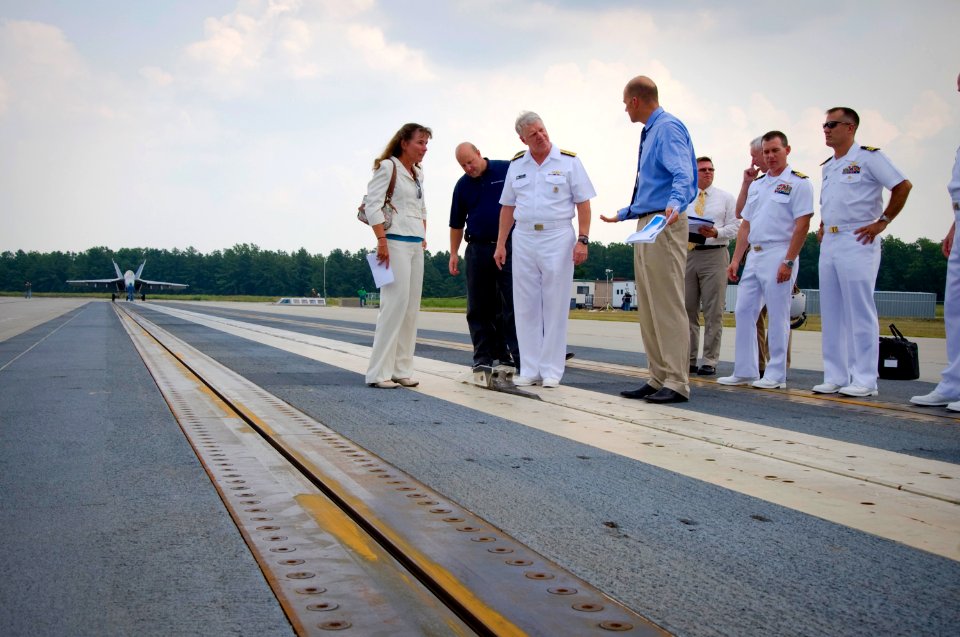 US Navy 110722-N-ZB612-224 Chief of Naval Operations (CNO) Adm. Gary Roughead, center, inspects the electromagnetic aviation launching system (EMAL