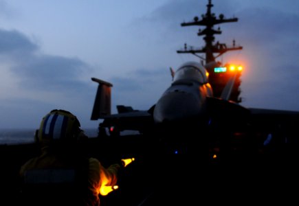 US Navy 110718-N-XE109-544 Aviation Boatswain's Mate (Handling) 1st Class Maungwai Soe performs pre-flight launch checks on an F-A-18F Super Hornet