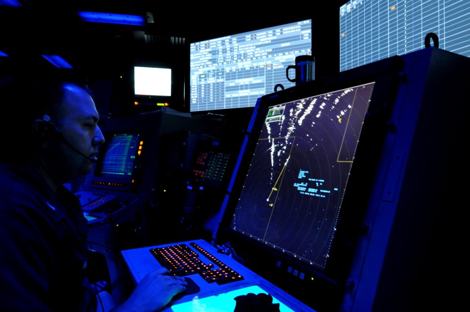 US Navy 110720-N-TU894-195 Air-Traffic Controller 1st Class David Viger controls aircraft in the Carrier Air Traffic Control Center aboard the airc