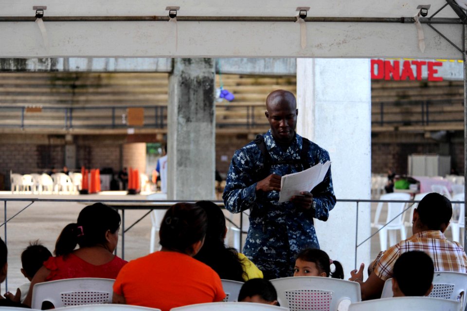 US Navy 110719-F-ET173-022 Hospitalman Agustus Lartey, from Ghana, reviews forms of patients waiting to receive medical treatment