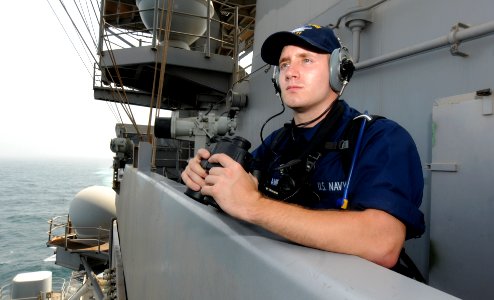US Navy 110723-N-QL471-036 Seaman Tyler D. Nordland stands lookout watch on vulture's row aboard the aircraft carrier USS George H.W. Bush (CVN 77) photo