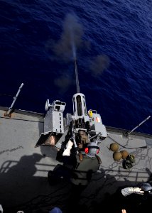 US Navy 110719-N-BK435-072 Gunner's Mate 2nd Class Patrick Boettger, assigned to the submarine tender USS Frank Cable (AS 40), fires a Mark 38 25mm