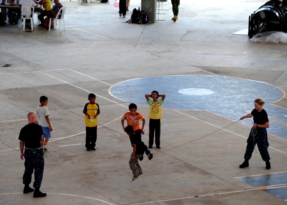 US Navy 110721-N-QD416-269 Sailors jump rope with Salvadoran children at the Polideportivo medical site in Acajutla, El Salvador, during Continuing