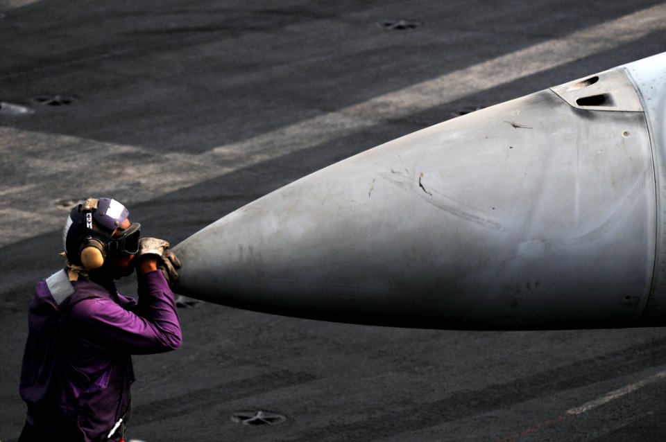 US Navy 110719-N-XE109-147 Aviation Boatswain's Mate (Fuel) 3rd Class Bryan Herring takes a moment to relax on the flight deck aboard the aircraft