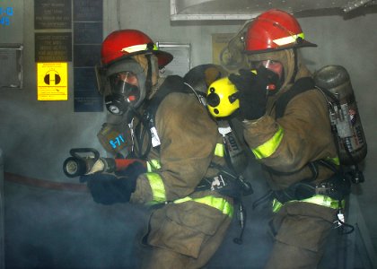 US Navy 110721-N-VA590-216 Repair locker personnel respond to a simulated fire during a general quarters drill aboard the aircraft carrier USS Abra photo