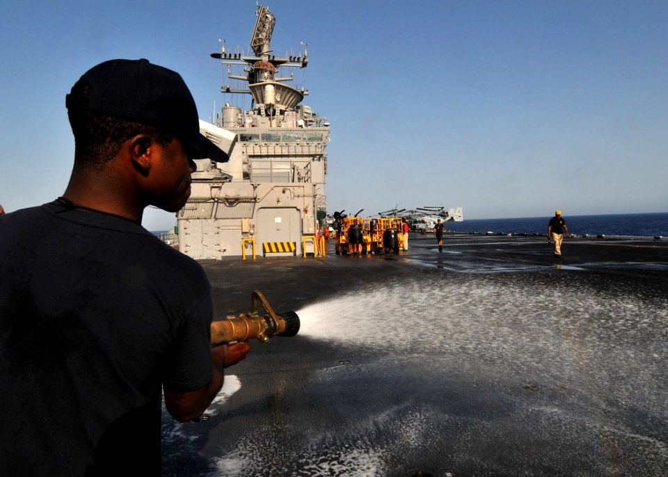 US Navy 110723-N-KA046-004 Aviation Boatswain's Mate (Handling) 1st Class Devon Caldeira participates in a flight deck scrub down aboard the multip