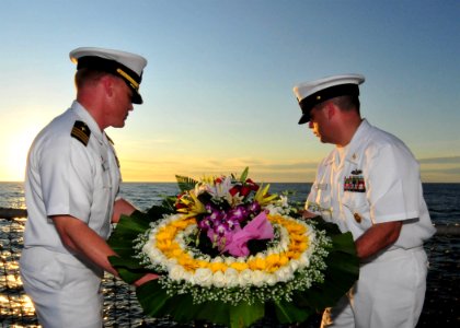 US Navy 110721-N-XR557-064 Cmdr. Stephen Erb, left, and Command Master Chief Chris Detje prepare to place a wreath in the ocean, commemorating the