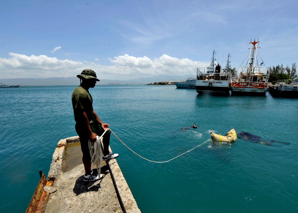 US Navy 110726-N-KB666-335 Marine Seaman Verron Charleton, a diver from the Royal Bahamas Defense Force, tends a line during lift bag operations