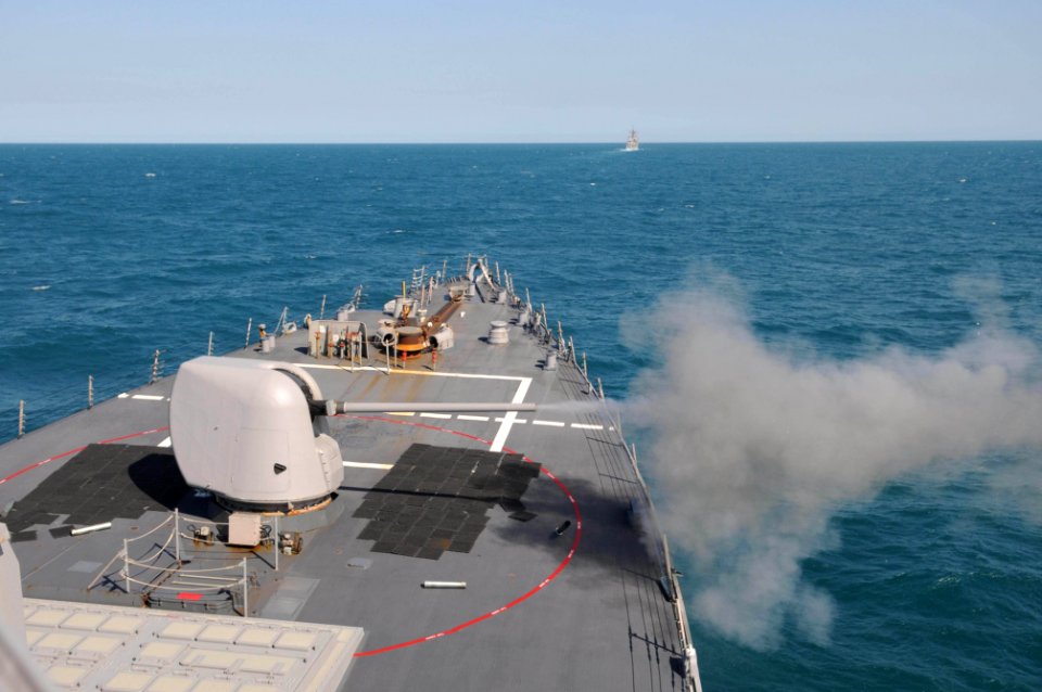 US Navy 110722-N-IO627-095 The MK-45 5-inch-54-caliber lightweight gun of the guided-missile cruiser USS Curtis Wilbur (DDG 54) is fired during a l