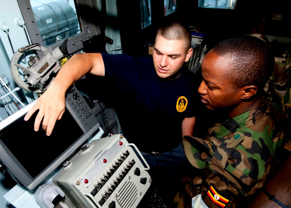 US Navy 110726-N-OV802-072 Quartermaster Seaman Kyle Seaux trains Tanzanian navy Lance Cpl. S.K. Rutungu in navigation