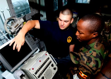 US Navy 110726-N-OV802-072 Quartermaster Seaman Kyle Seaux trains Tanzanian navy Lance Cpl. S.K. Rutungu in navigation